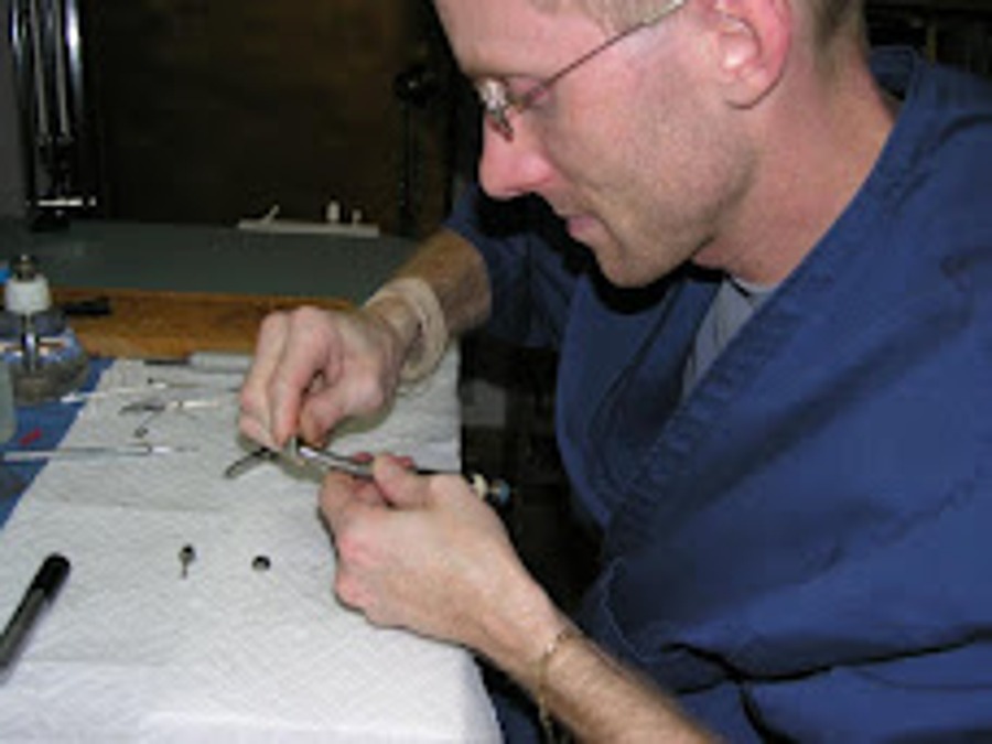 Dental Magic Repair technician servicing a handpiece